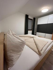 a bed with two pillows on it in a room at FeWo HansUndChrista in Mariapfarr