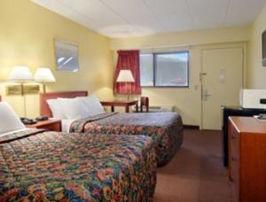 a hotel room with two beds and a window at Days Inn by Wyndham Athens in Athens