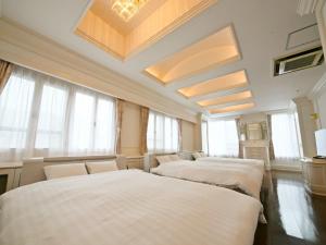 uma fila de quatro camas num quarto com janelas em Pleasure Maruyama - Vacation STAY 52729v em Sapporo