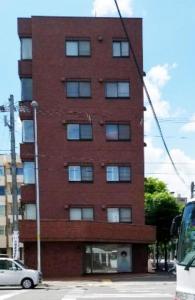 a tall brick building on the side of a street at Pleasure Maruyama - Vacation STAY 52798v in Sapporo