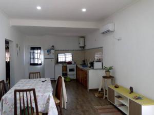 a kitchen with a table and a dining room at Virgen de Lourdes in Goya