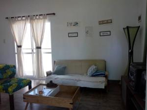 a living room with a bed and a coffee table at Virgen de Lourdes in Goya