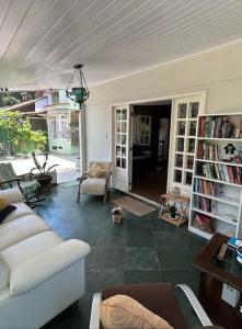 a living room with a couch and a dog in it at Casa Clorophila in Vila Velha