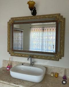 a sink in a bathroom with a mirror at Casa Clorophila in Vila Velha