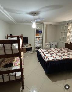 a bedroom with a bed and a tv in it at Casa Clorophila in Vila Velha