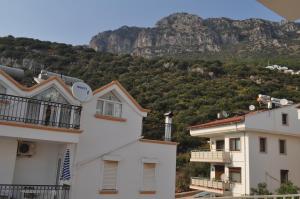 a view of the mountains from between two buildings at Smyrna Pansiyon in Kaş