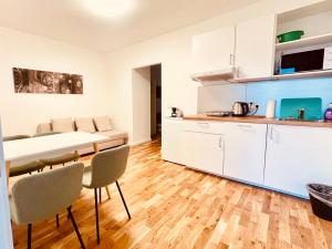 a kitchen and dining room with a table and chairs at Sievering18 A-B in Vienna