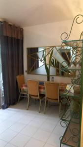 a dining room with a table and chairs and a dining room at Appartement EMISYD in Libreville