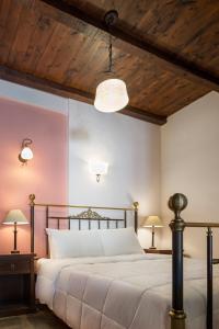 a bedroom with a large bed with a wooden ceiling at Porto Kale Guesthouse in Porto Kagio