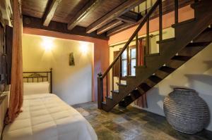 a room with a staircase and a vase at Porto Kale Guesthouse in Porto Kagio