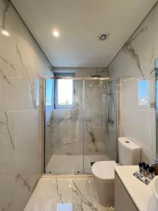 a bathroom with a shower and a toilet and a sink at Brittos Home Lovely Stay - Villa Prime in VN de Famalicão Braga in Vila Nova de Famalicão