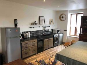 a kitchen with a refrigerator and a washer and dryer at Bellevue in Treignac