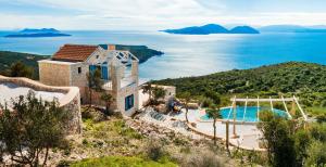 an aerial view of a villa with a swimming pool at Heliopetra Luxury Villa Lefkas in Vasiliki