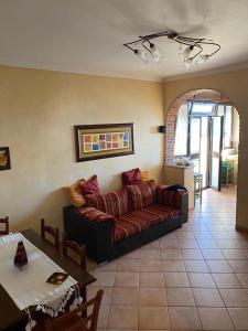 a living room with a couch and a table at Casa Vacanze Vanessa House in Ladispoli