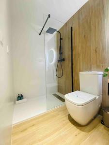 a bathroom with a white toilet and a shower at Nice & Cozy Flat Close The Beach in Valencia