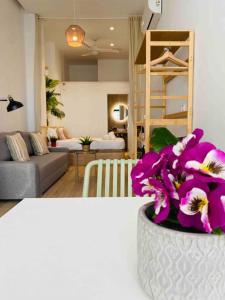 a living room with a vase with purple flowers in it at Nice & Cozy Flat Close The Beach in Valencia