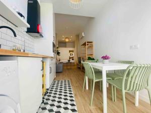 a kitchen with a table and chairs in a room at Nice & Cozy Flat Close The Beach in Valencia