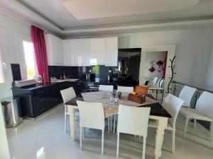 a kitchen and dining room with a table and chairs at Centaur Villa in Agios Ioannis Pelio