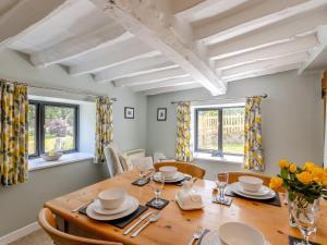 a dining room with a wooden table and chairs at 2 Bed in Mold 74791 in Nannerch