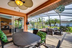 a patio with a table and chairs and a pool at Kissimmee Home with Private Pool, 18 Mi to Disney! in Kissimmee