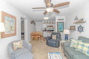 a living room with two chairs and a ceiling fan at Fishing Dock, Trailer Parking, Gated, Beach Access in Myrtle Beach