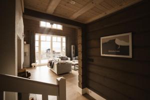 a living room with wood paneled walls and a window at Åre Valley Lodges - Grand Ski Lodge in Åre