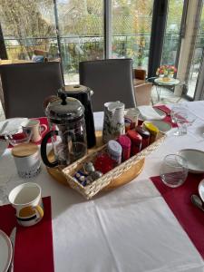 a table with a basket of food on a table at Le jardin des Vérottes in Beaune