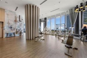 a large room with a gym with a lot of windows at High Floor Corner 2 BDR in Hyde Resort in Hollywood