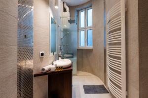a bathroom with a sink and a shower at Luna Apartment in Krakow