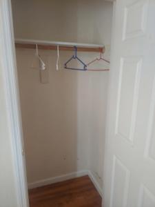 a room with a closet with hangers on a wall at Crystal Room 1 Guest House near 12mins to EWR airport / Prudential / NJIT / Penn station in Newark