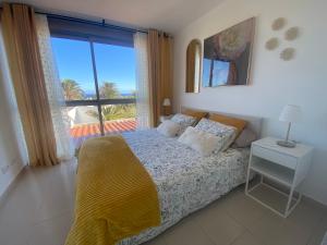 a bedroom with a bed with a view of the ocean at CarpeDiem Costa de Antigua in Costa de Antigua