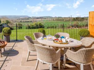 a patio with a table and chairs and a fence at 3 Bed in Hay-on-Wye 91642 in Mansel Gamage