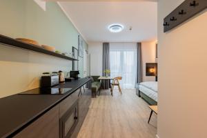 a room with a kitchen and a living room at Nena Apartments Berlin - Adlershof - "New Opening 2024" in Berlin