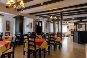 a restaurant with red and yellow tables and chairs at Poiana Soarelui in Moieciu de Sus