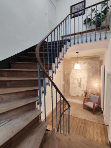 a staircase with blue railings in a house at Appartement au coeur de la Suisse normande in Thury-Harcourt