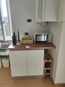 a kitchen with a counter with a microwave on it at Casa Mancini in Rome