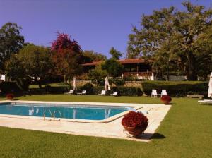 a swimming pool in the yard of a house at Otium Country House in Alvorge