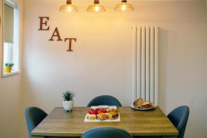 a dining room table with a plate of food on it at Stylish and cosy cottage in the heart of Yorkshire in Leeds