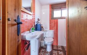 a bathroom with a white toilet and a sink at Casa Rural Pío in Montilla +18 photos