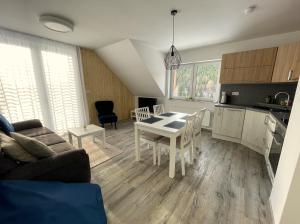 a kitchen and living room with a table and chairs at Apartmán Pod Mamutem in Dolní Morava