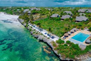 an aerial view of a resort with a swimming pool and the ocean at Kasha Boutique Hotel in Matemwe