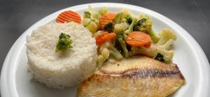 a plate of food with rice and vegetables and fish at Motel Atos ADULTS ONLY in Sao Paulo