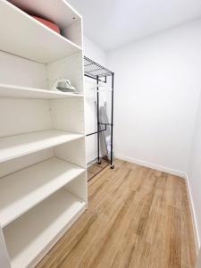 a closet with white shelves and a wooden floor at Vivienda El Viajero in Valverde
