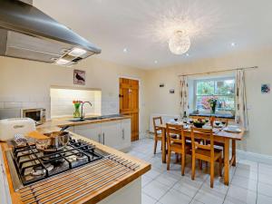 a kitchen with a table and a stove top oven at 3 Bed in Bamford PK838 in Bamford