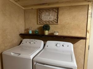 a kitchen with a white stove and a sink at Cuddle Up in Ruidoso