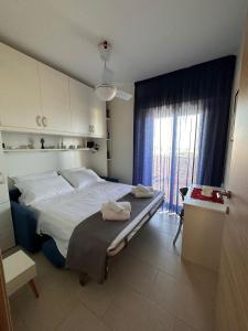 a bedroom with a large bed and a window at La casa al Mare in Erice