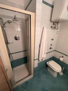 a bathroom with a shower and a toilet in it at La casa al Mare in Erice +22 photos