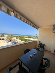 a balcony with a table and chairs and a large window at La casa al Mare in Erice
