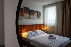 a bedroom with a bed with a towel on it at Hotel National in Zagreb