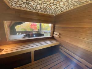 a sauna with a window in a wooden room at Horenbecca Bistro & Wellness in Horebeke